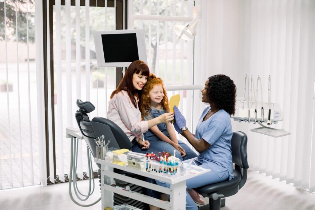 Family dental services in Bradenton showing a child and parent at the dentist with caring staff.