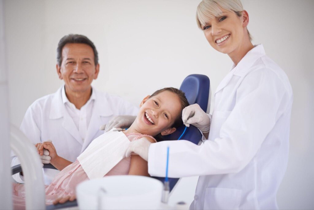 Smiling child at a Sarasota family dentist visit with caring dentists, showing a positive family dental experience.